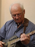 Kerry Spitzer playing guitar in the studio