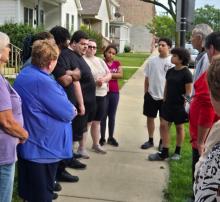 Nearly two-dozen people held a sidewalk vigil Sunday evening for a gunshot victim. 